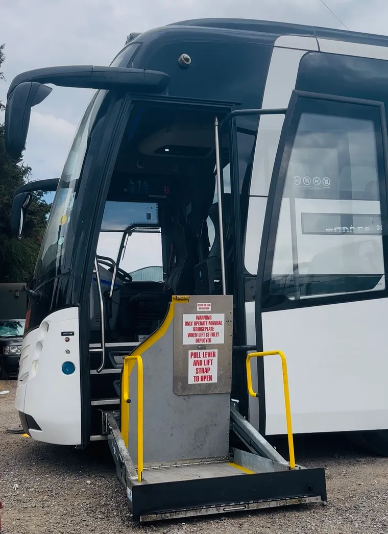 The wheelchair lift deployed at the door of a PSVAR compliant coach