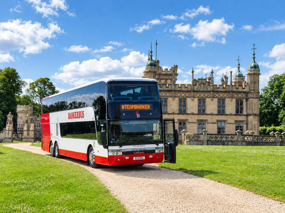 A Barker Bus double decker at a stately home, its destination blind reading Team Barker